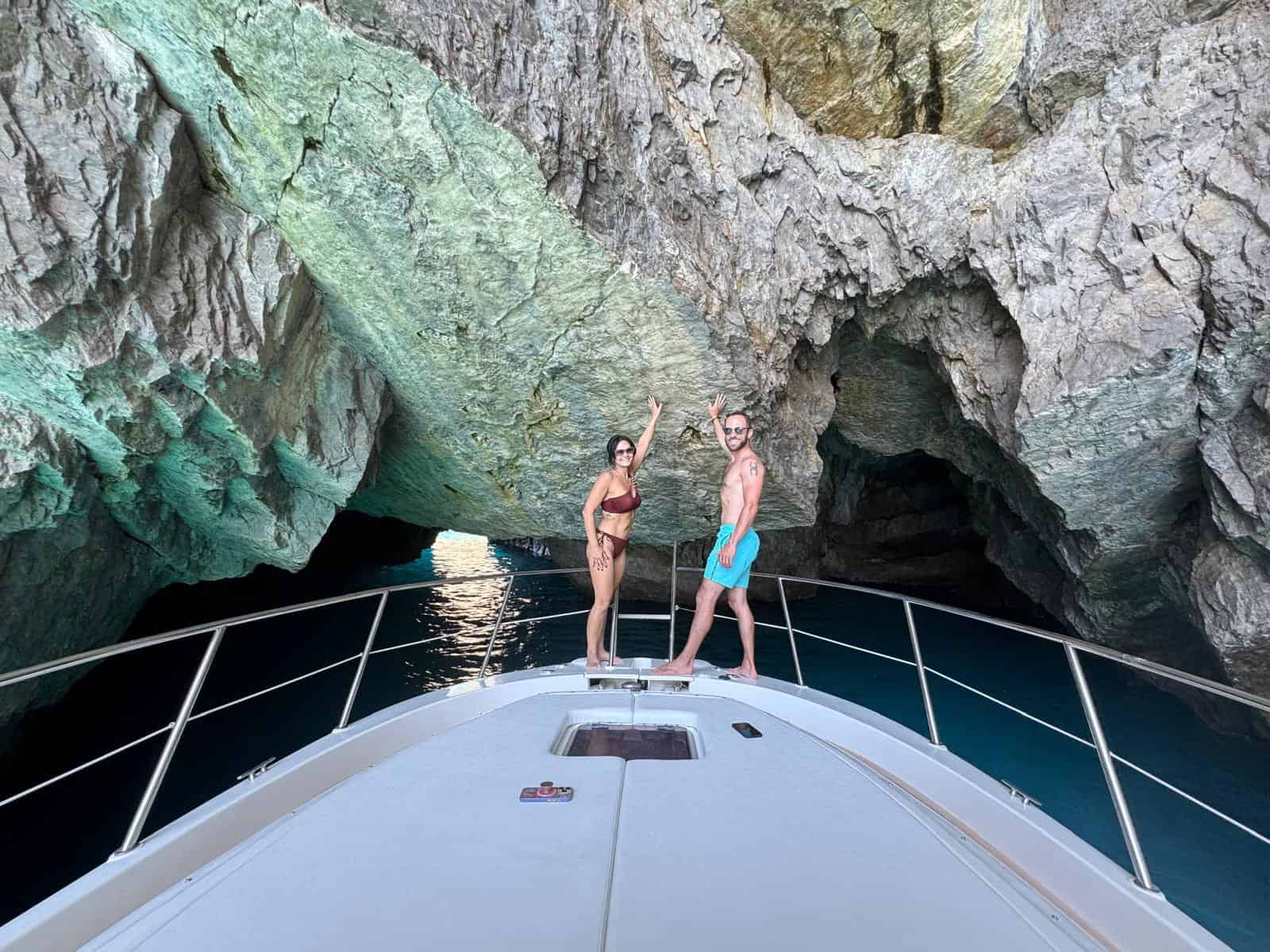 Private boat passing beside the Faraglioni rocks in Capri